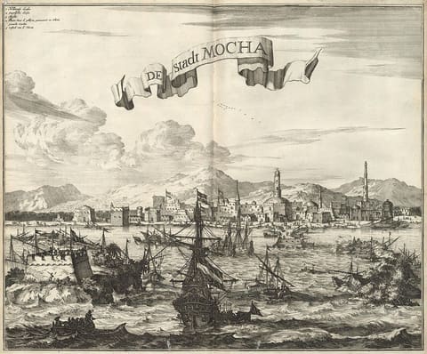 A seventeenth-century Dutch engraved panorama of Mocha seen from the sea, flat-roofed houses and a domed mosque behind a low waterfront, several East Indiamen at anchor in the roadstead and camels on the quay.