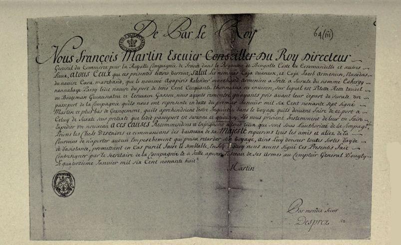 Photographic facsimile of the French pass of the Quedagh Merchant. A handwritten French document headed De Par le Roy, opening Nous Francois Martin Escuier Conseiller du Roy Directeur, with two seals at left and the signature Martin. The enclosure mark 64(iii) appears at the top right corner.
